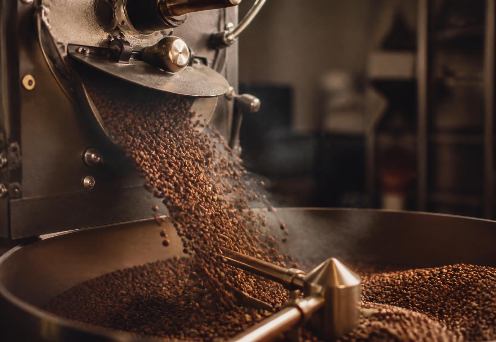 Freshly roasted coffee beans falling into the cooling tray